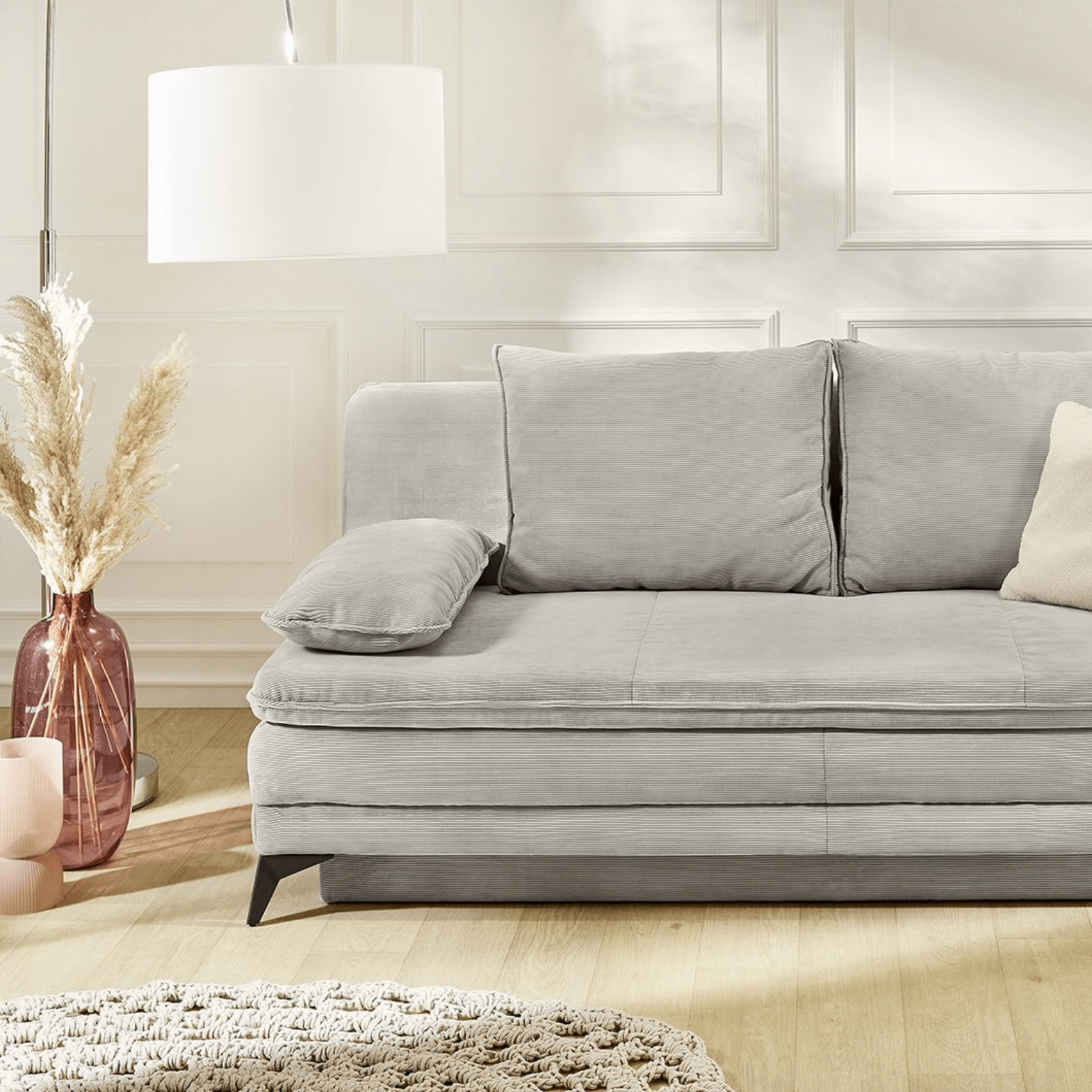Canapé-lit moderne LAURIN en velours côtelé fin gris avec pieds noirs et coffre de lit intégré